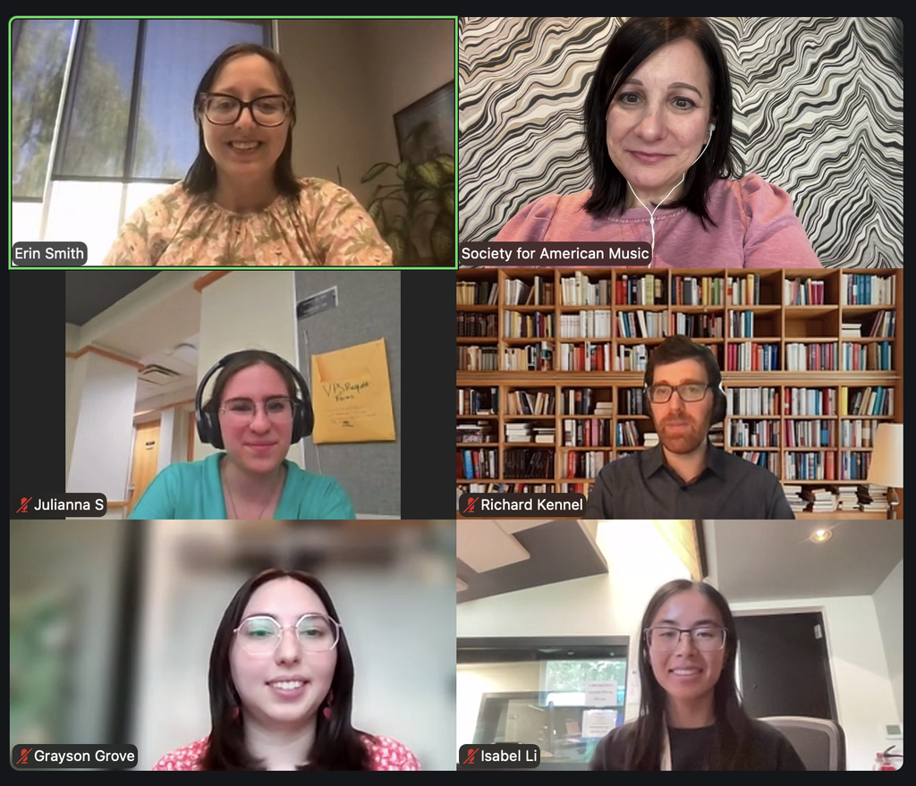 A Zoom video call with six participants, each in their own window. They are smiling, and backgrounds include bookshelves, artwork, and office settings. Usernames are visible below their images.